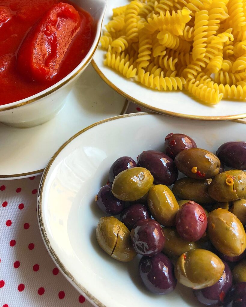 ingredients for Fusilli alla Puttanesca: pasta, olives and tomatoes