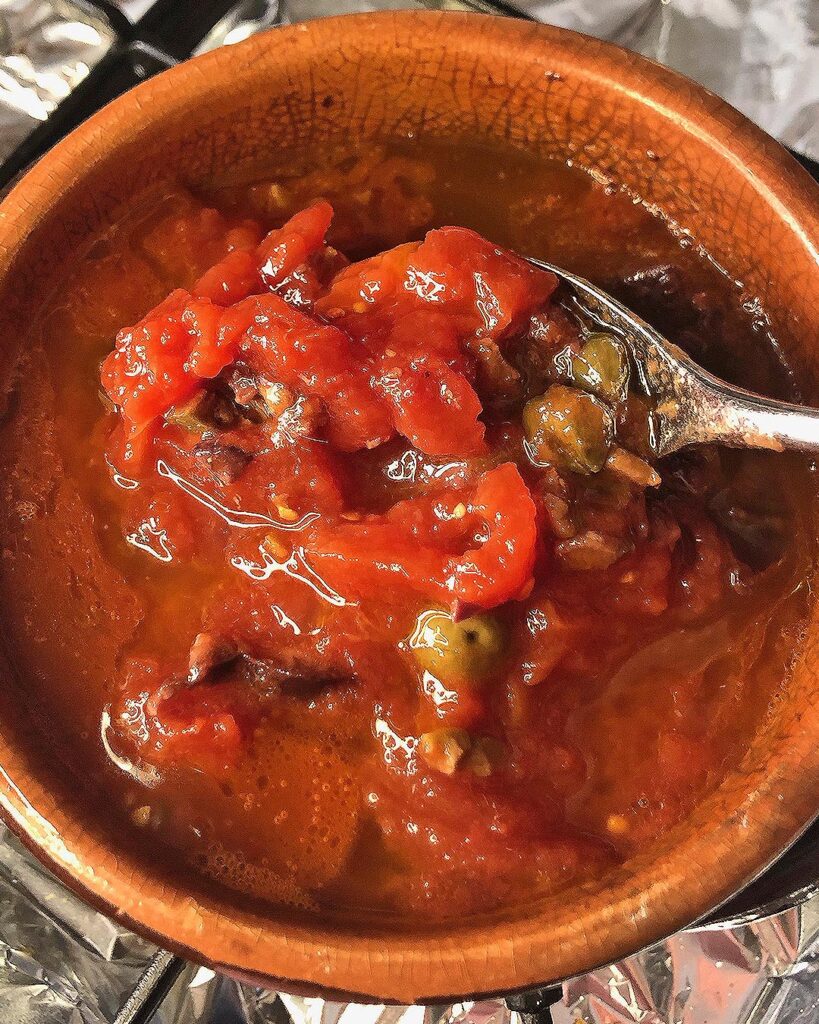 tomatoes are added to the Puttanesca sauce