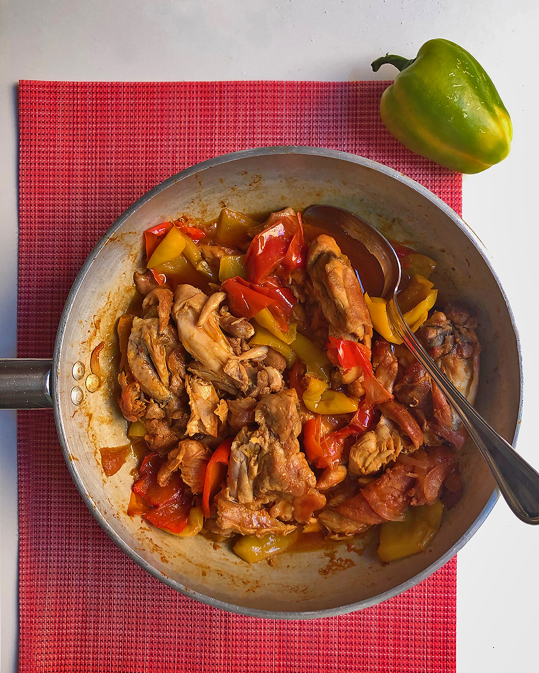 a pan full of chicken with bell pepper ready to be taste